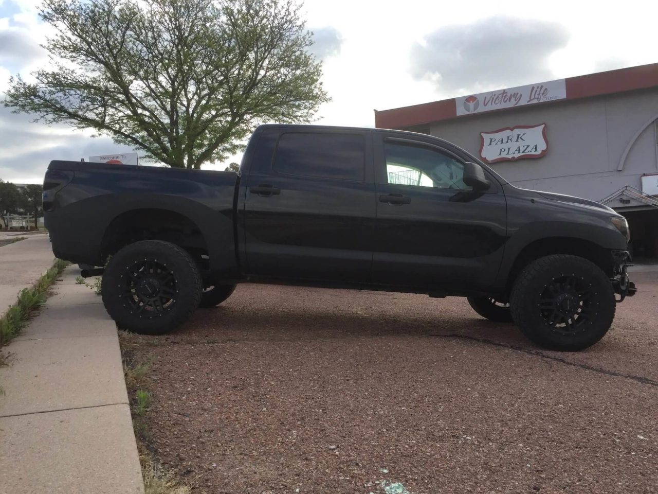 Black pickup truck with ProCote liner along wheel wells and rocker panel